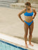 Pool side view of athletic fixed-back Torquay bikini top in Cancun Blue by JAYD Swimwear.