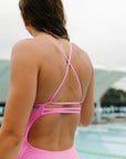 Close back strap view of Airlie One Piece Athletic Swimsuit in Fairy Floss pink by JAYD Swimwear