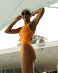 Lauren swims in Airlie One Piece Athletic Swimsuit in Sunshine by JAYD Swimwear