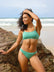 Front view of model wearing athletic, cheeky coverage JAYD Swimwear Minnie bikini bottoms in matcha green.