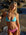 Front view of model on a beach wearing JAYD Swimwear athletic bikini top Triangle in Mykonos Blue.