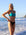 Front view of model on a beach wearing JAYD Swimwear athletic bikini top torquay in Atlantic Green.