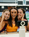 Girls taking a picture with the JAYD magnetic selfie water bottle.