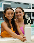 Girls taking a picture with the JAYD magnetic selfie water bottle.