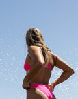 Close-up of the JAYD Swimwear ZALI mid-cut bikini bottom in Pink Sorbet on ironwoman Olivia Corrin, showing the sculpted fit and structured waistband.