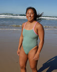 Athlete Sara wearing the fixed back chlorine resistant Lennox one piece by JAYD Swimwear in the colour Matcha with contrasting fairy floss strap detailing.