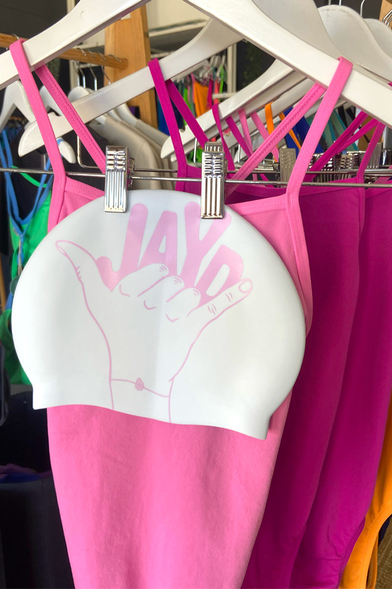 Pink Shaka JAYD swim cap paired with pink JAYD one piece swimsuits