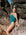Woman in a cove JAYD one piece standing on rocky terrain