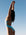 Madi wearing the Tallow One Piece swimsuit in MYKONOS blue against a clear blue sky.