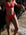 Madi wears the Connie full-coverage bottom in Fiesta, standing by a rocky shoreline.