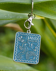 JAYD Swimwear shell stamp keyring, depicting a seahorse and various shells hanging on a branch.