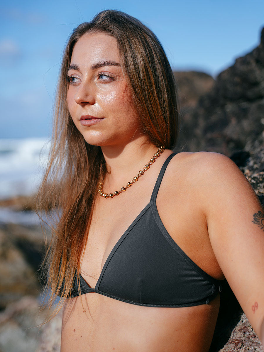 JAYD model Cass wearing the Kiama one piece bikini top on the beach, a popular triangle style classic that is practical, stylish and functional.