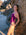 JAYD Swimwear athlete Charlotte Derbyshire leaning against a rock wearing the Lennox one piece swimsuit in sangria with contrasting orchid shoulder straps and 5 hip panel cut-outs.