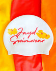 White swim cap with 'Jayd Swimwear' text and floral designs on a colorful background