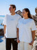 JAYD athlete Madi Armstrong and her brother standing on a beach, wearing the Swim For A Cure fundraiser t-shirt.
