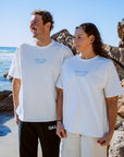 JAYD athlete Madi Armstrong and her brother standing on a beach, wearing the Swim For A Cure fundraiser t-shirt.