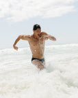 Ocean running in Ramshark Mens Briefs in Black by JAYD Swimwear.