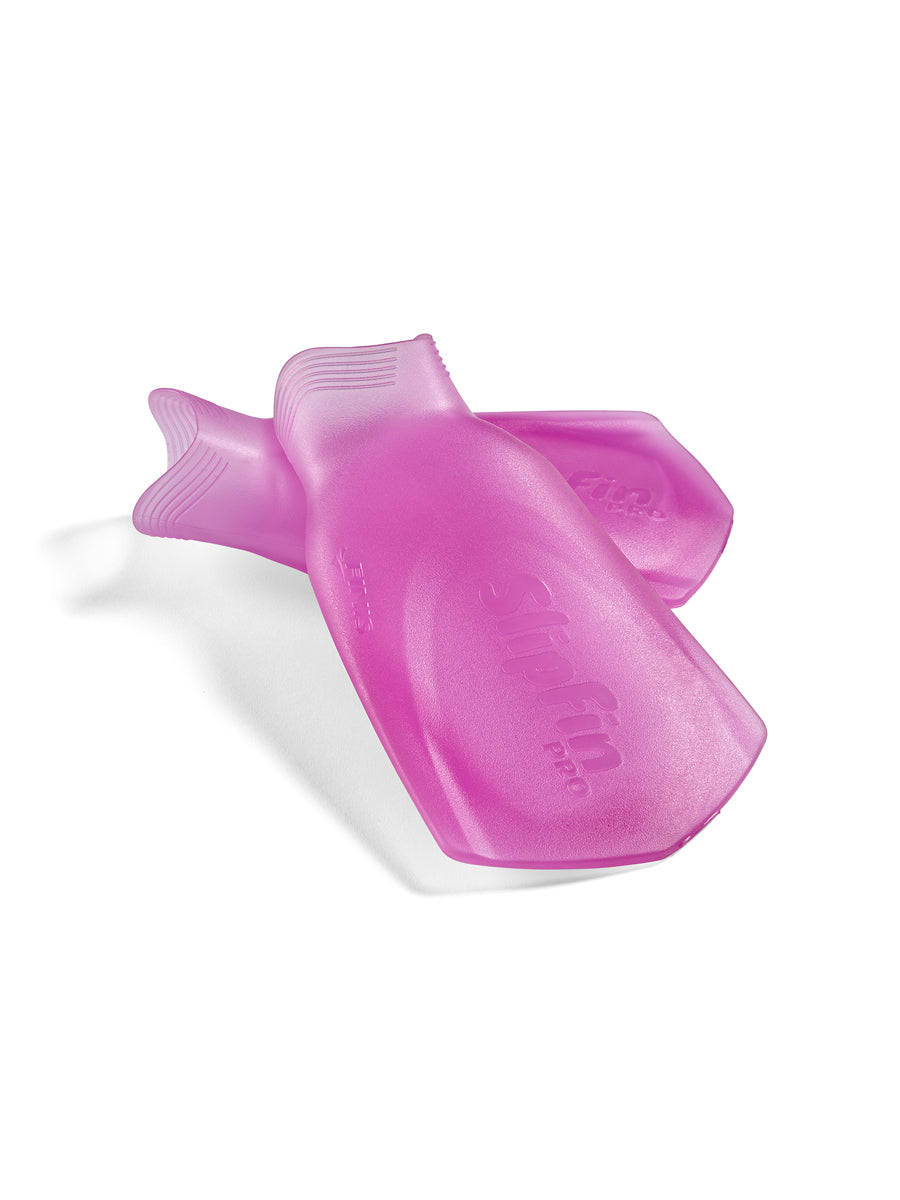 A pair of translucent pink FINIS Swim Slip Fins with ribbed edges, displayed on a clean white background.