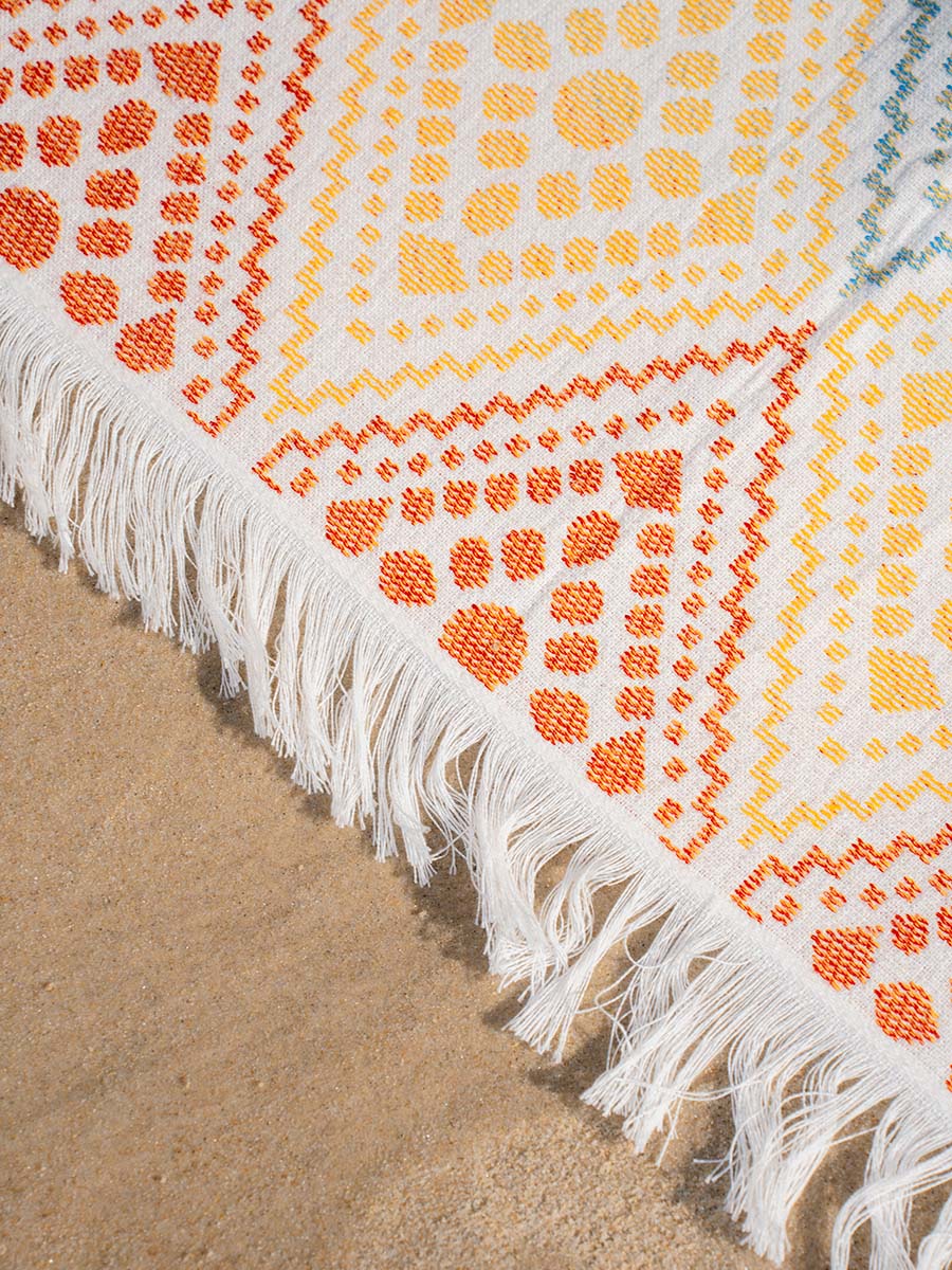The Solana JAYD towel, woven as a Turkish pestemal with a soft terry back, compact and cute with a colourful geometric pattern.