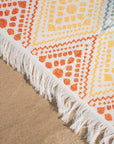 The Solana JAYD towel, woven as a Turkish pestemal with a soft terry back, compact and cute with a colourful geometric pattern.