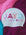 White swim cap with colorful squiggly  text 'JAYD SWIMWEAR' on a multicolored background