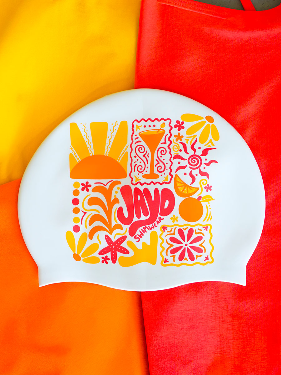 Colorful swim cap with floral and abstract designs on a multicolored background