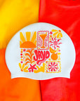 Colorful swim cap with floral and abstract designs on a multicolored background