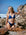 JAYD model Chloe standing on a rocky beach looking into the distance wearing the Triangle Bikini Top in Navy.