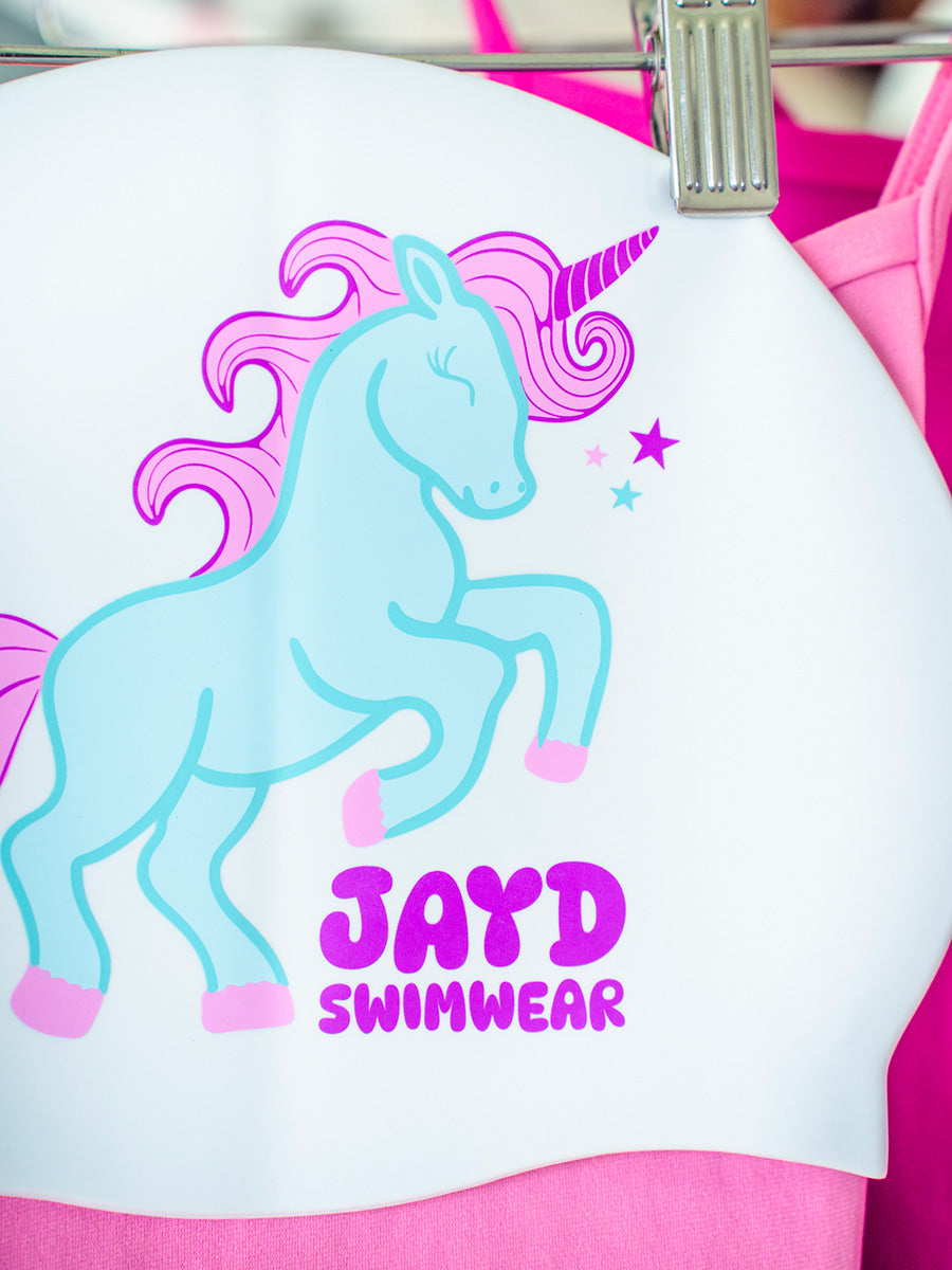 Blue and pink unicorn graphic on a white swim cap.