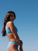 Woman in JAYD Nalu blue bikini against a clear blue sky. Blue colour is called Breeze