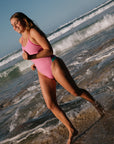 Athlete wearing the IBIZA chlorine resistant one piece designed by JAYD Swimwear. Featured colour is Fairy floss with contrasting hip cut outs and shoulder straps.