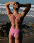 Athlete wearing the IBIZA chlorine resistant one piece designed by JAYD Swimwear. Featured colour is Fairy floss with contrasting hip cut outs. Ibiza one piece has adjustable fixed back straps to assist with tension distribution across the shoulders. 