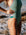 athletic swimmer wearing the IBIZA swimsuit made by JAYD Swimwear in the Matcha colours, suit features include contrasting straps and hip cut outs. Built for performance.