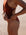 Person wearing a Cinnamon coloured JAYD swimsuit on a sandy background