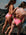 Two women in JAYD swimwear's Vibe coloured one pieces standing on a rocky beach.